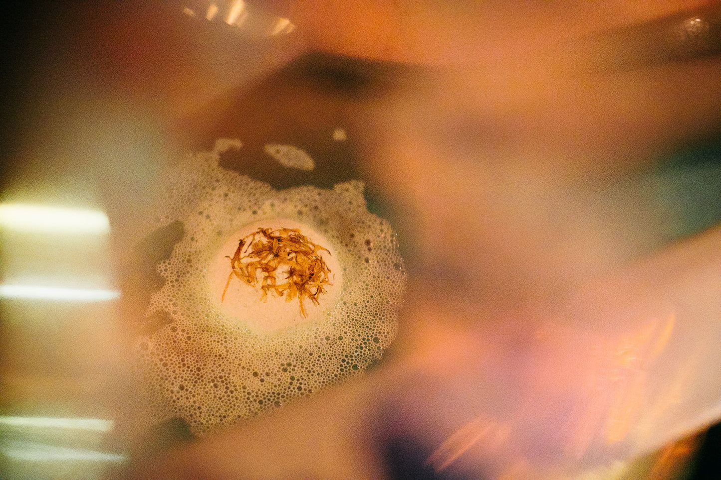 Tea Tree Toke Soak Bath Bomb fizzing in a bath with calendula petals and aromatic essential oils.