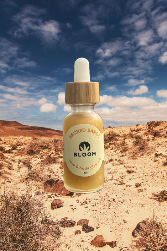 Sacred Sands Glow Oil in roller and 1 oz. dropper forms, featuring a nourishing blend of sea buckthorn oil, hemp extract, and citrus oils for a luminous, sun-kissed glow.