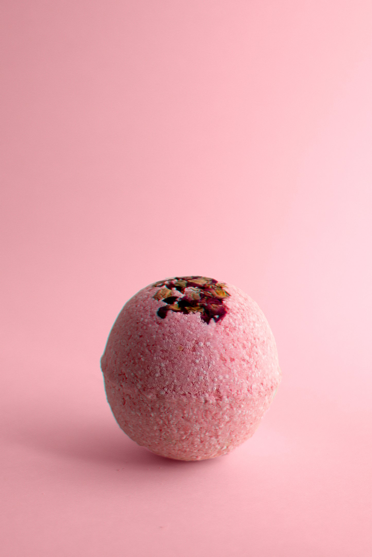 Therapeutic Aphrodite Bath Bomb with rose petals and essential oils.