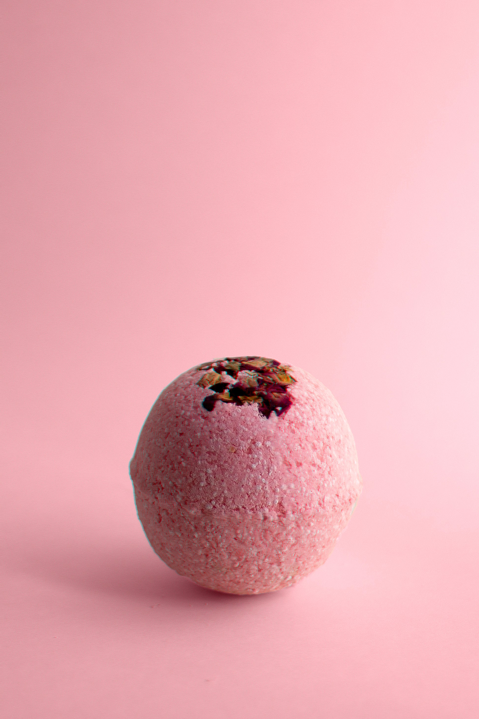 Therapeutic Aphrodite Bath Bomb with rose petals and essential oils.