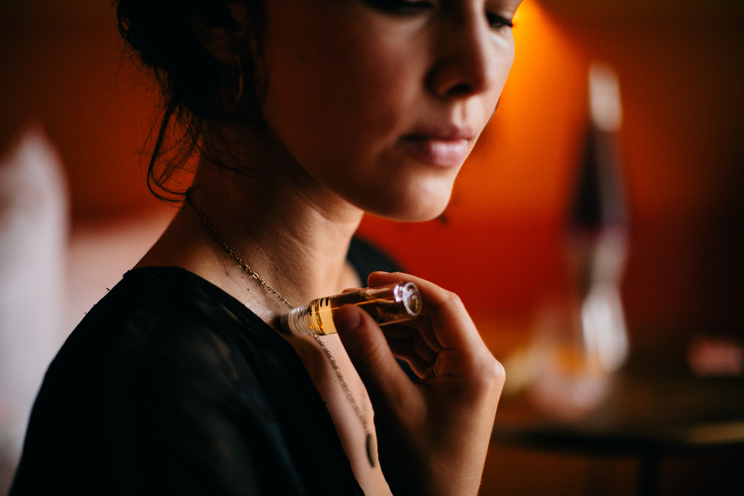 Wanderwood Headache Roller with essential oils like peppermint, eucalyptus, and cedarwood to relieve headaches, anxiety, and stress, and a Brazilian Clear Quartz crystal for added tranquility.