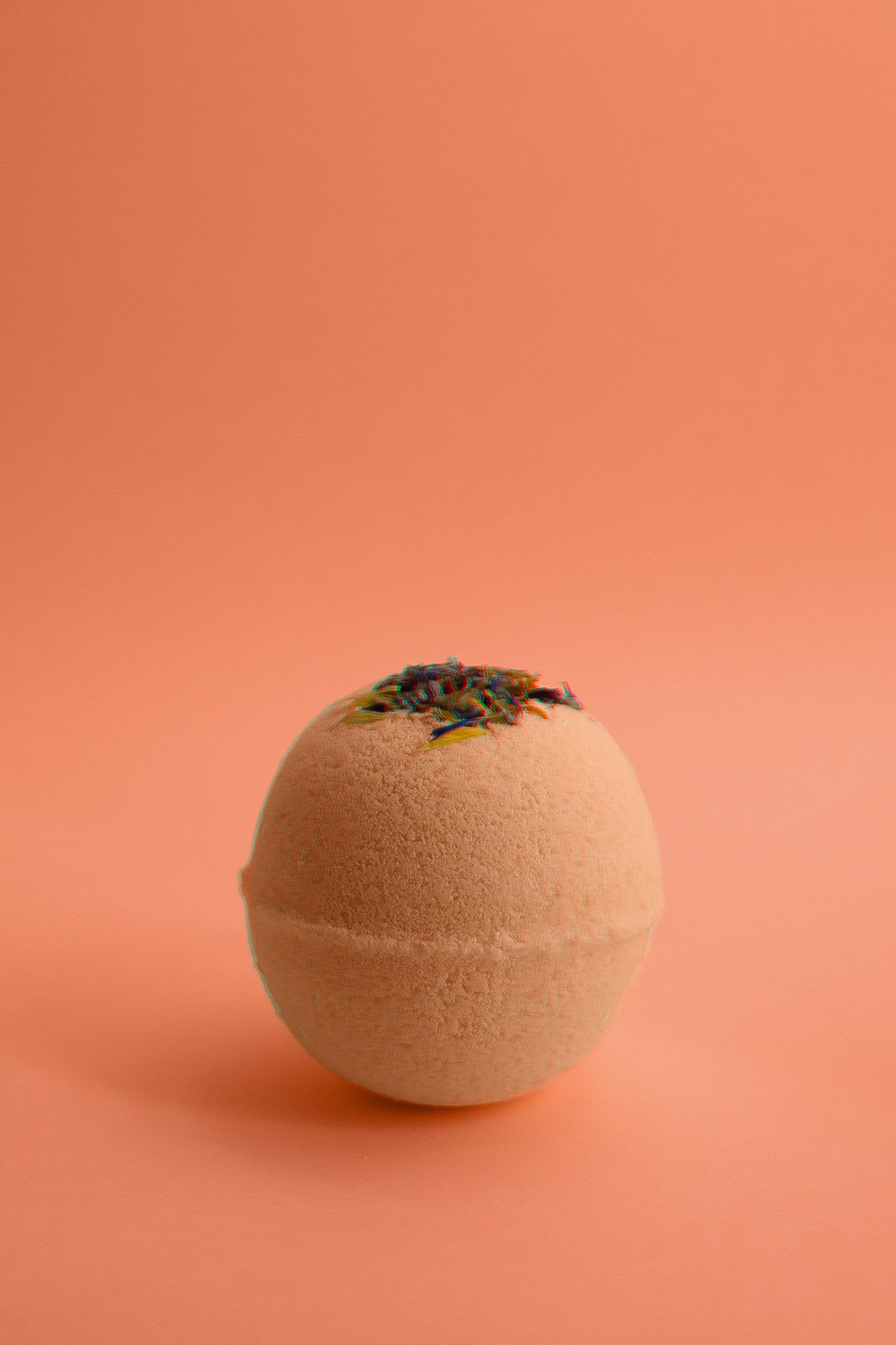 Flower Child Bath Bomb fizzing in water with dried flower petals and citrus aroma.