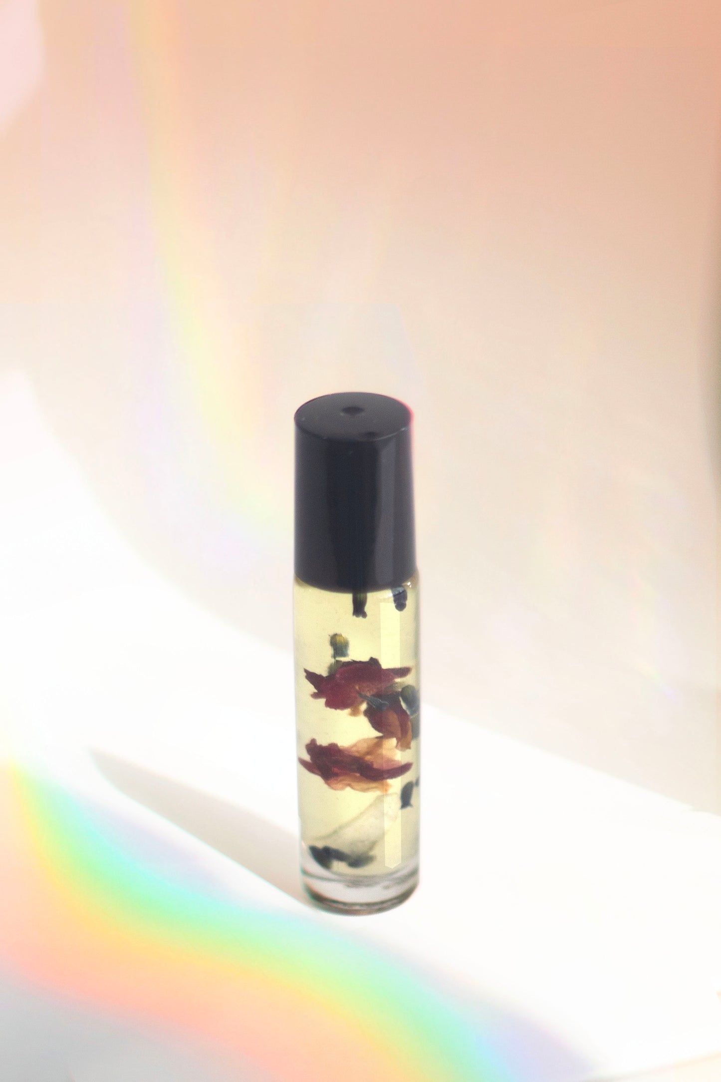 Wanderwood Headache Roller with essential oils like peppermint, eucalyptus, and cedarwood to relieve headaches, anxiety, and stress, and a Brazilian Clear Quartz crystal for added tranquility.