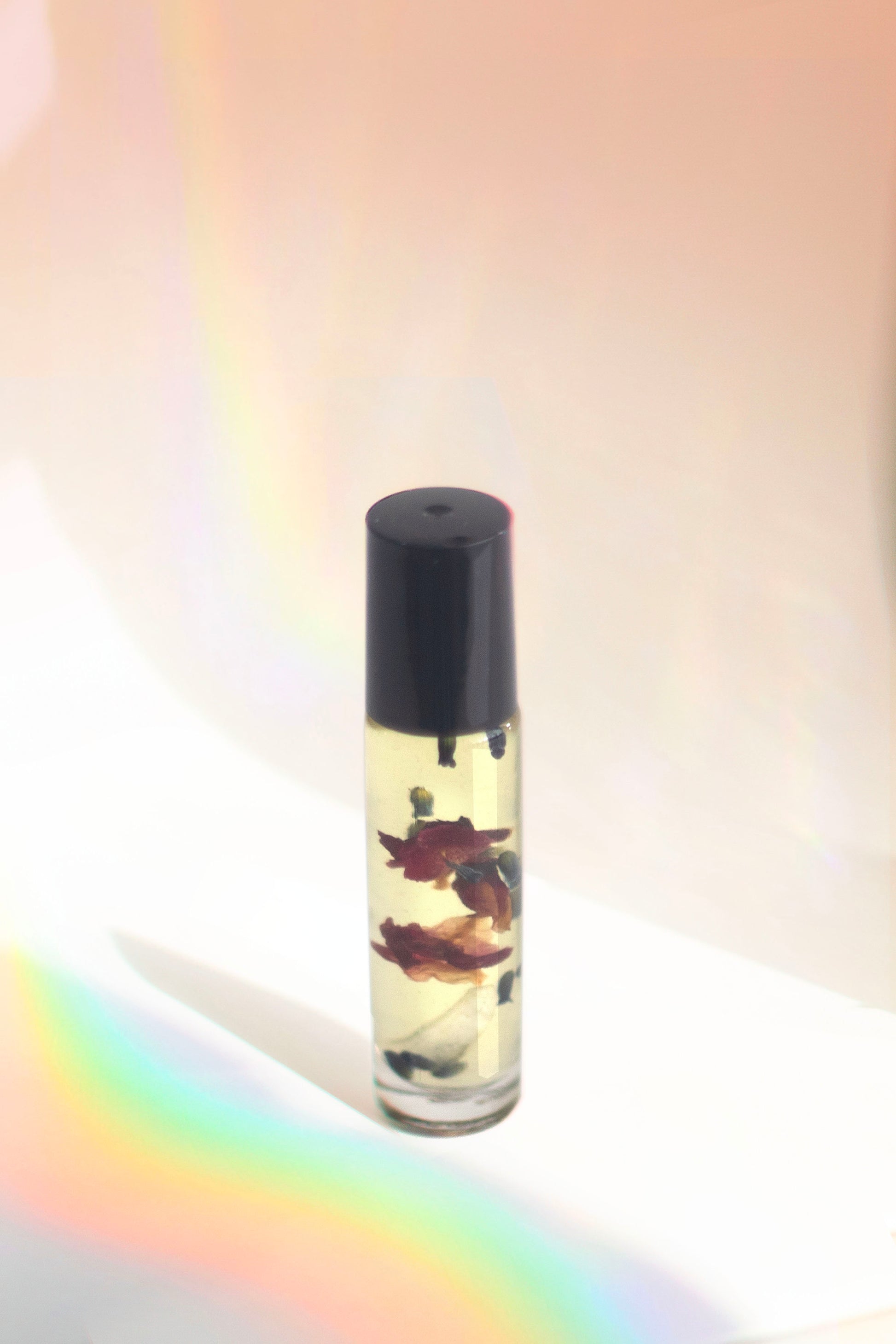 Wanderwood Headache Roller with essential oils like peppermint, eucalyptus, and cedarwood to relieve headaches, anxiety, and stress, and a Brazilian Clear Quartz crystal for added tranquility.